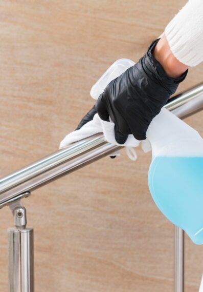 hands-with-gloves-disinfecting-hand-rail_cropped